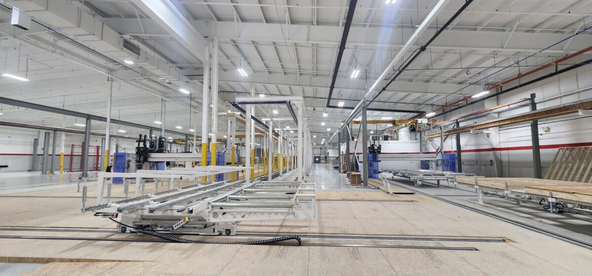 Interior of PrimeFab manufacturing facility showing panelized wall production line and automated equipment for prefabricated construction
